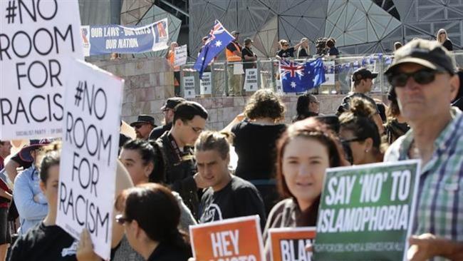Protesters hold banners condemning a march by the far-right group Reclaim Australia in Melbourne