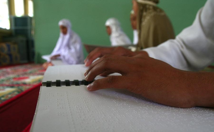Visually Impaired Muslim reading Quran