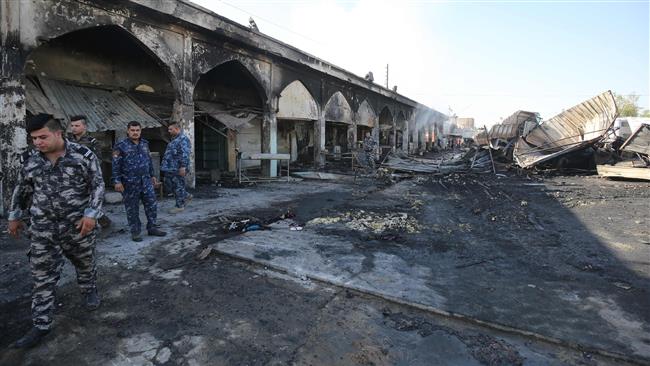 Iraqi policemen inspect the aftermath of a mortar and bombing attack on the mausoleum of Sayyid Muhammad ibn Ali al-Hadi in the city of Balad, situated ۸۰ kilometres (۵۰ miles) north of Baghdad, July ۸, ۲۰۱۶