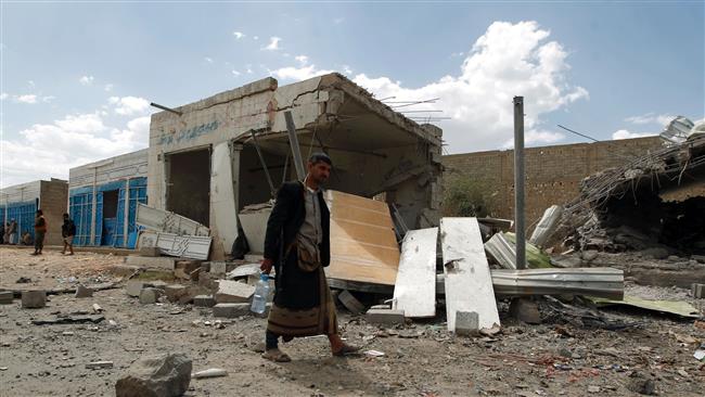 A Yemeni man walks amid the ruins of a building in Yemen’s capital, Sana’a, after it was hit by a Saudi airstrike, August 29, 2016. (Photo by AFP)