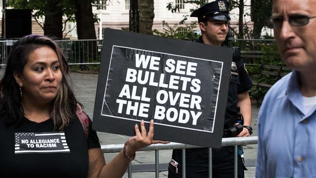 A Black Lives Matter activist holds up a sign during a protest against police brutality at City Hall Park, August 1, 2016 in New York City.