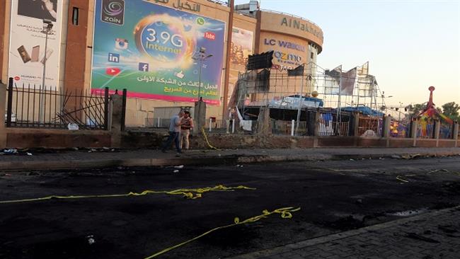 A member of Iraqi security forces walks past the site of a car bomb attacks against al-Nakheel Mall in Baghdad, Iraq, on September 10, 2016. (Reuters)