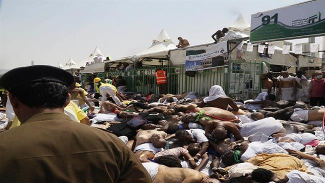 In this photo, dated September 24, 2015, Muslim pilgrims and first responders gather around the bodies of people crushed and then piled up in Mina, Saudi Arabia, during the annual Hajj pilgrimage. (By AP)