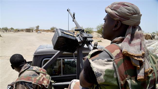 This May 25, 2015 file photo shows soldiers patrolling a road between Diffa and Bosso in the southeast of Niger near the border with Nigeria. (Photo by AFP)