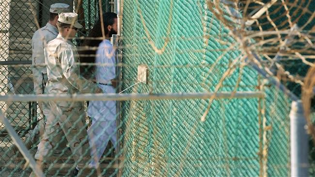 This AFP file photo taken on March 29, 2010 shows US military guards moving a detainee to an undefined facility inside Camp Delta in the Detention Center at Guantanamo Bay, Cuba.