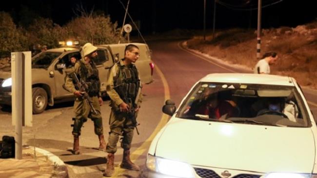 Israeli military forces stand near the site of an alleged stabbing attack outside the illegal Efrat settlement in the occupied West Bank on September 18, 2016.