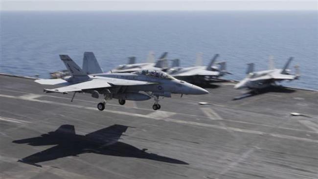 A US plane lands on the flight deck of the USS Theodore Roosevelt aircraft carrier deployed to strike purported Daesh targets in Syria and Iraq. (Photo by Reuters)
