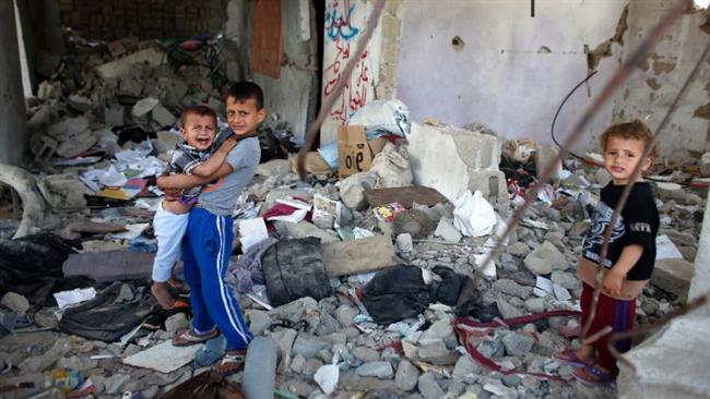 Palestinian children stand amid the rubble of their partially-rebuilt house, which was destroyed during the 2014 50-day Israeli war on Gaza, May 11, 2015.