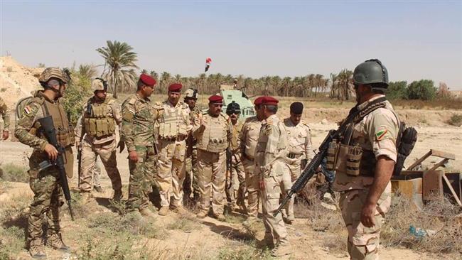 This photo provided by the Arabic-language al-Sumaria TV network shows Iraqi government forces in Jazirah al-Baghdadi district on September 23, 2016.