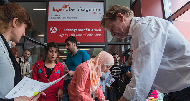 This file photo taken on June 16, 2016 shows participants registering for a professional training fair aimed at refugees, at an employment office in Berlin (AFP Photo)