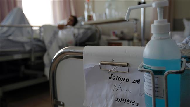 A militant injured during the Syrian war lies on a bed at Ziv Hospital in the northern Israeli town of Safed on March 10, 2016. (photo by AFP)