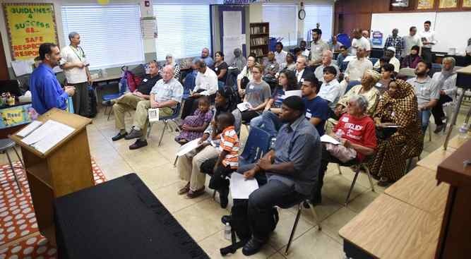 Dr. Ahmad Azzam, left, speaks to visitors during the Islamic Center of Hawthorne’s annual Open Mosque Day