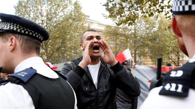 A protester shouts slogans during a demonstration against the visit of Bahrain