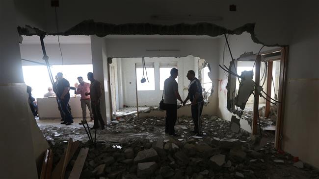 Palestinians check the flat of Amjad Aliwi after Israeli authorities demolished it in the northern occupied West Bank city of Nablus on October 11, 2016. (Photo by AFP)
