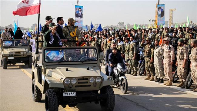 IRGC second-in-command Hossein Salami (1st L) salutes as his car passes by a group of armed forces in this file photo.