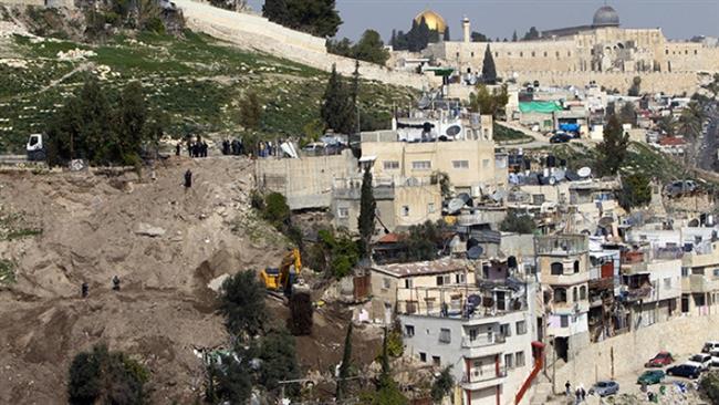 In this file photo, an Israeli army bulldozer destroys Palestinian houses in the East Jerusalem al-Quds neighborhood of Silwan. (Photo by AFP)