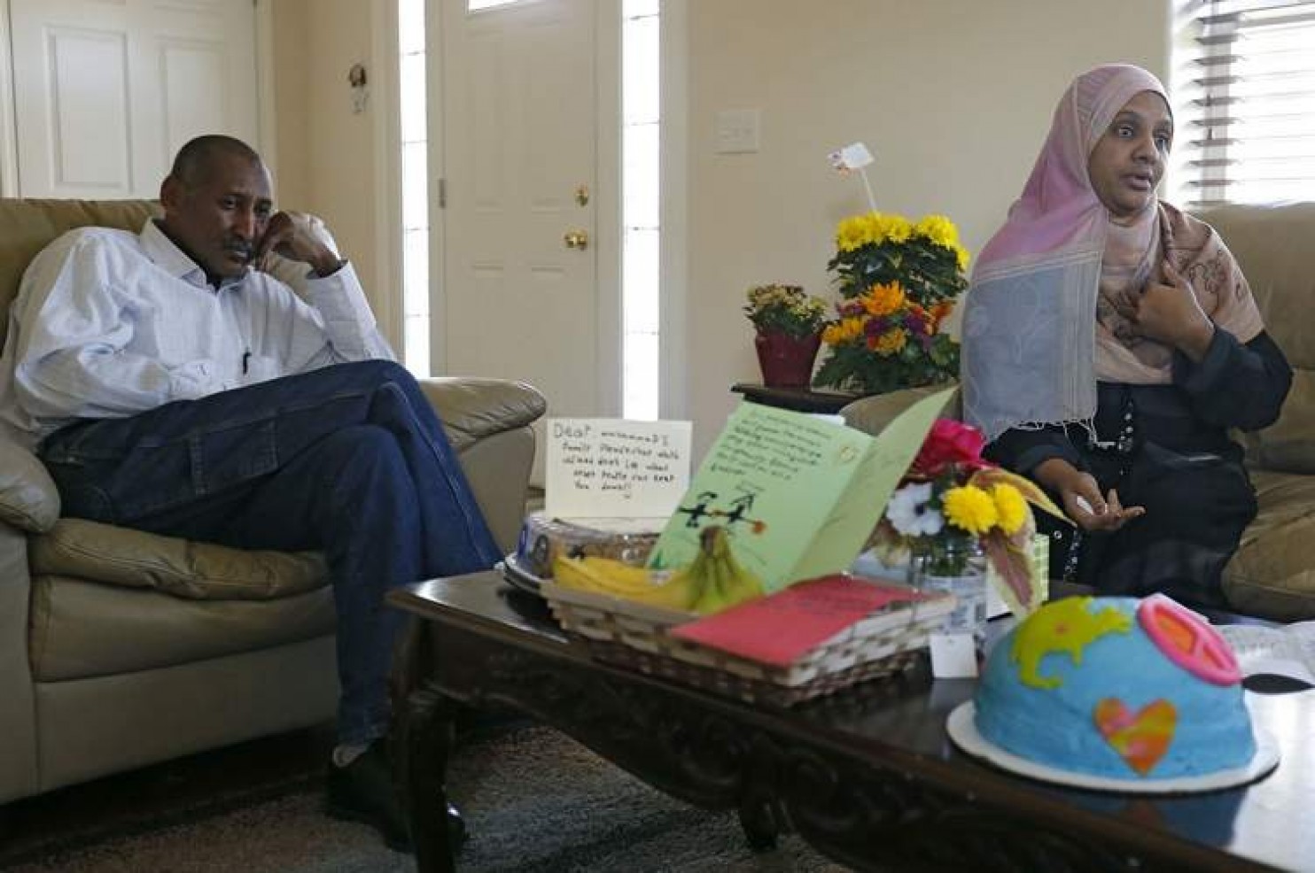 Amar Samel (left) and Muna Abdalla talk about a hate message taped to the door of their house in Iowa City