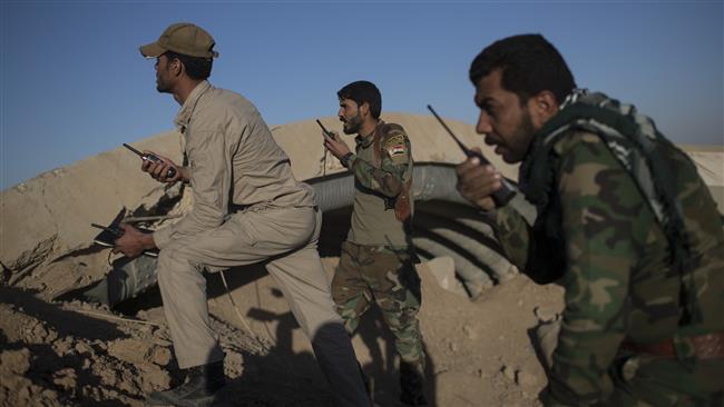 The Popular Mobilization Units (PMU), also known as Hashd al-Shaabi forces, talk on the radio as they watch Daesh positions in Tal Afar Airport, west of Mosul, Iraq, November 20, 2016. (Photo by AP)
