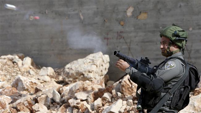 An Israeli soldier fires a teargas canister during clashes following a demonstration against the expropriation of Palestinian land by Israel in the occupied West Bank on November 18, 2016. (Photo by AFP)