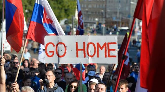 Participants hold flags and a banner during an anti-refugee rally organized by an initiative called “Stop Islamization of Europe” in Bratislava, Slovakia, September 12, 2015. (Photo by AFP)