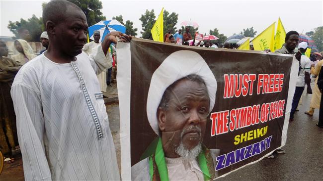Protesters from the Islamic Movement in Nigeria holding a banner with a photograph of detained Shia cleric Sheikh Ibrahim Zakzaky, in the northern Nigerian city of Kano