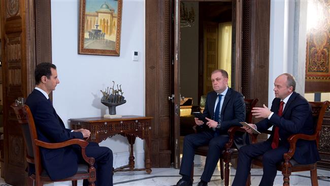President Bashar al-Assad (L) attends an interview with the Russian TV channels, Russia 24 and NTV, in the capital Damascus on December 14, 2016. (Photo by Reuters)