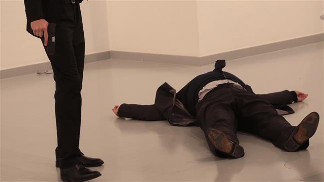 An unnamed gunman holds the gun after shooting the Russian Ambassador to Turkey, Andrey Karlov, at a photo gallery in Ankara, Turkey, on December 19, 2016. (Photo by AP)