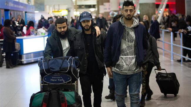 Adam Saleh, center, and Slim Albaher, right, after arriving at John F. Kennedy International Airport on Wednesday, December, 21, 2016. (Photo by The New York Times)