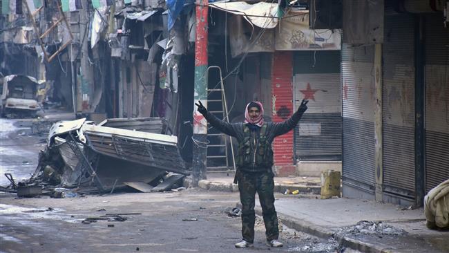 A Syrian man gestures in the Syrian city of Aleppo on December 23, 2016 after Syrian government forces retook control of the whole embattled city. (Photo by AFP)