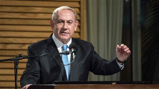 Israeli Prime Minister Benjamin Netanyahu delivers a speech before lighting the candles during the start of the Jewish light festival of Hanukkah in Rhavat Ronit, south of Netanya, on December 24, 2016. (Photo by AFP)
