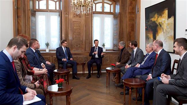 Syrian President Bashar al-Assad (C-R) speaks in a meeting with a delegation, comprising Russian and European parliamentarians, in Damascus on December 29, 2016. (Photo by SANA)