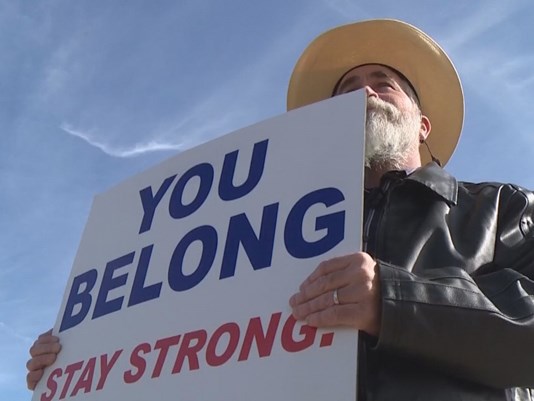 Justin Normand holds the sign that made him a viral internet sensation.