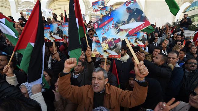 Tunisians take part in a demonstration against Israel holding placards depicting assassinated drone expert, Mohamed Zaouari, in the capital, Tunis, December 20, 2016.