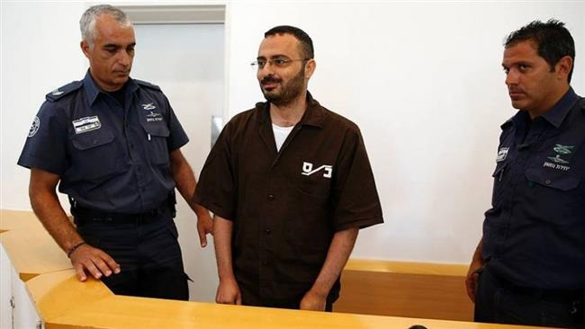 Waheed Borsh (C), a Palestinian UN employee, looks on during his indictment at a district court in Be’er Sheva on August 28, 2016. (Photo by AFP)