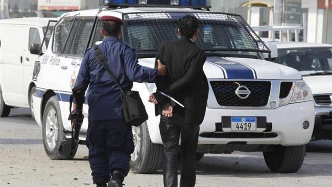 A policeman arrests Bahraini human rights activist Said Yousif during his march towards Eker village, Bahrain. (Photo by Reuters)