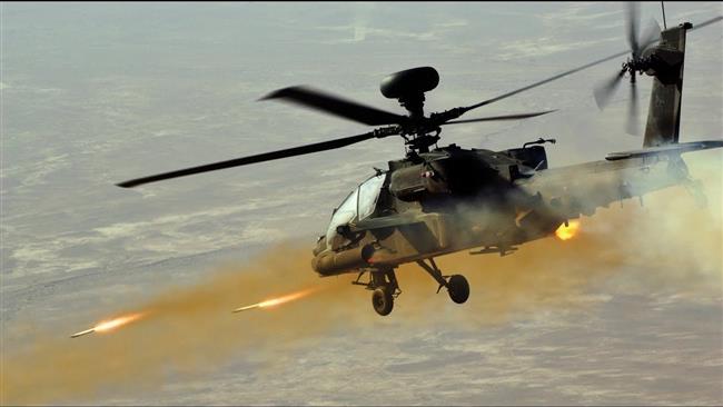 US Apache combat helicopter firing rockets.
