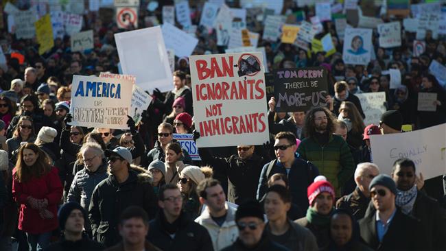 Protesters march on Pennsylvania Avenue while protesting against US President Trump’s recent ban on refugees entering the US, in Washington, DC, February 4, 2017. (Photo by AFP)