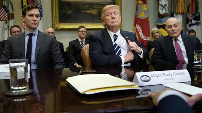 Senior Advisor Jared Kushner (L) and Secretary of Homeland Security John Kelly (R) listen while US President Donald Trump puts his papers away at the beginning of a meeting on cyber security in the Roosevelt Room of the White House January 31, 2017 in Washington, DC. (Photo by AFP)