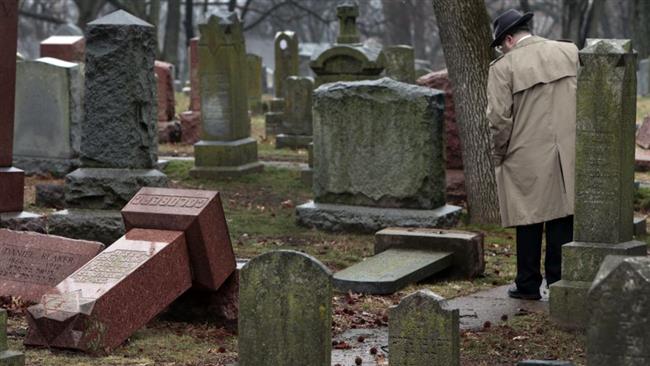 A man looks at vandalized tombstones at Chesed Shel Emeth Cemetery in University City, Missouri, February 21, 2017. (Photo by AP)