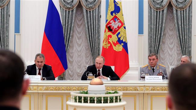 Russian President Vladimir Putin (C) attends a meeting with Northern Fleet officers, who took part in the anti-terror combat in the Mediterranean off the coast of Syria, at the Kremlin in Moscow on February 23, 2017. (Photo by AFP)