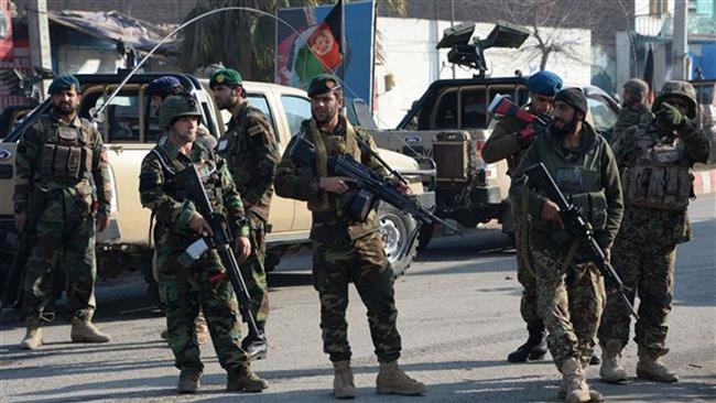 Afghan police officers keep watch along a street after an attack from a building close to the Pakistan consulate in the city of Jalalabad, eastern Afghanistan, Jan. 13, 2016. (Photo by AFP)