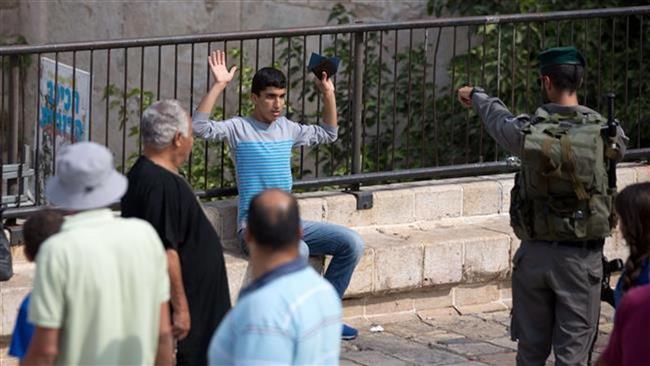 Israeli forces check a Palestinian man at the Damascus Gate in the Old City of East Jerusalem al-Quds