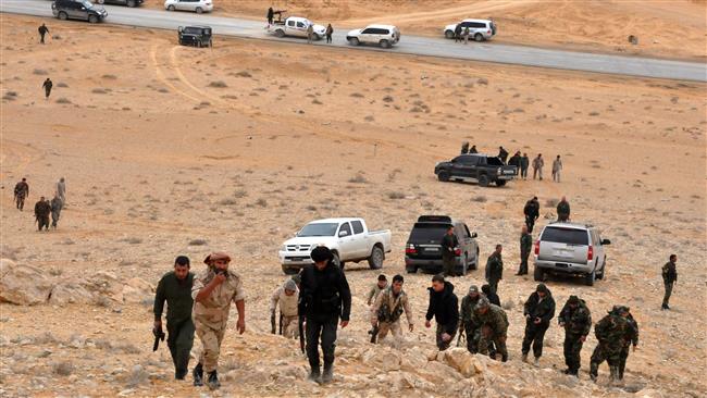 Syrian soldiers take positions as they advance to retake the ancient city of Palmyra from Daesh in a previous operation on March 2, 2017. (Photo by AFP)