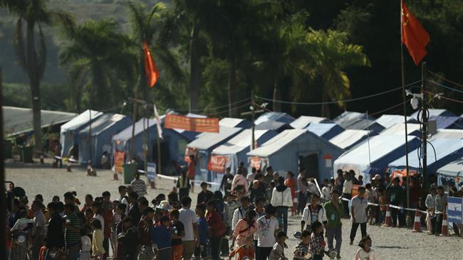 Refugees from Myanmar line up for food at a refugee camp in Wanding in China