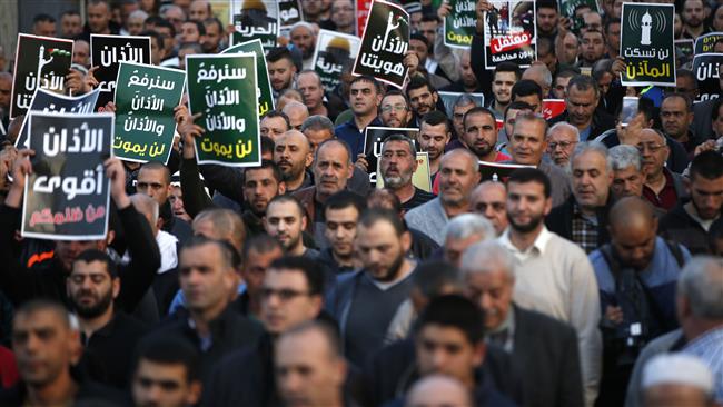 Palestinians march in the Palestinian town of Kabul during a demonstration against planned Israeli legislation aimed at silencing mosques on March 11, 2017.