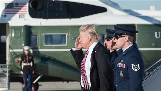 US President Donald Trump salutes as he steps off Air Force One at Andrews Air Force Base in Maryland upon his return from Philadelphia on January 26, 2017. (Photo by AFP)