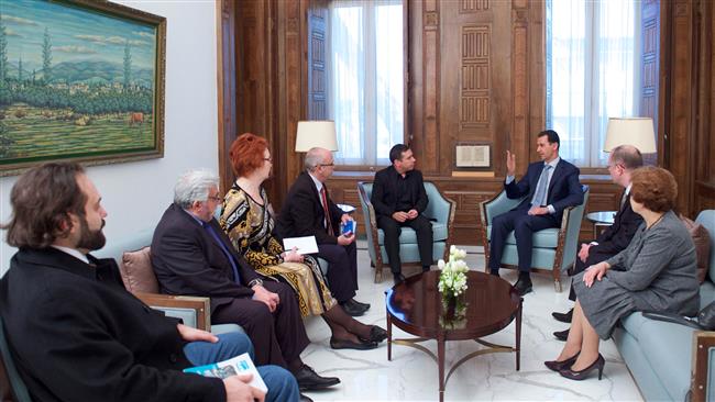 Syrian President Bashar al-Assad (3rd R) speaks with Deputy Chairman of the European Parliament’s Committee on Foreign Affairs Javier Couso (5th L) in the capital Damascus, on March 12, 2017. (Photo by SANA)