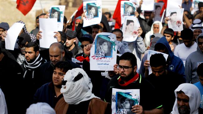 Mourners shout anti-regime slogans while holding photos of a martyr during his funeral procession in the village of Nawidarat south of Manama, Bahrain, February 21, 2017. (Photo by Reuters)