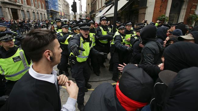 Anti-fascist activists clash with police as they counter protest against marches by the far-right English Defense League and Britain First in central London on April 1, 2017. (Photo by AFP)