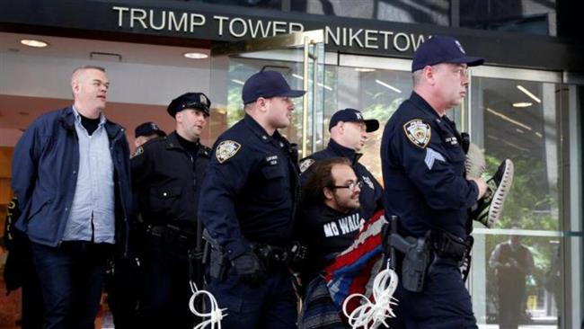 New York City police officers carry protestors to police vans after making arrests for demonstrating in Trump Tower on April 13, 2017. (Reuters photo)